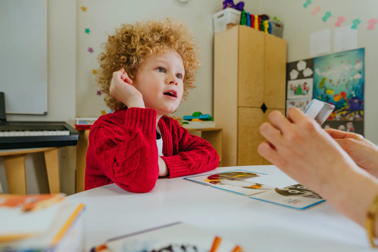 Eine Logopädin hilft einem Jungen, die Sprachstörung zu korrigieren